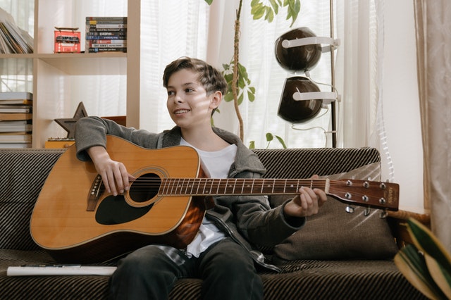 Son playing Guitar