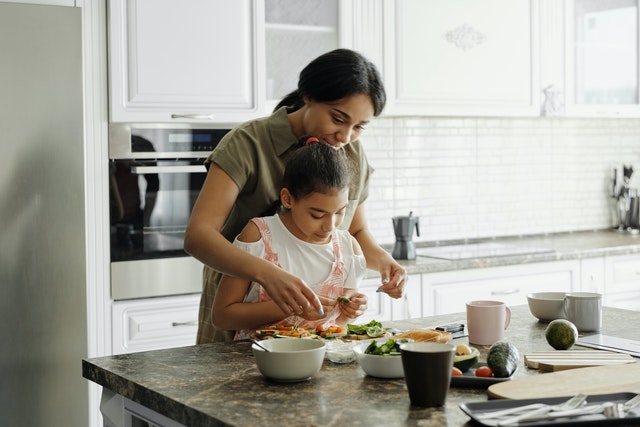 daughter helping her mother