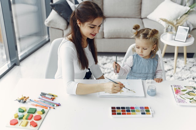 girl painting with family